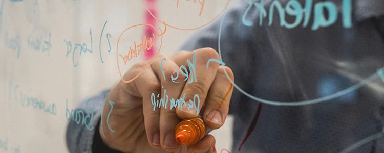 Person creating a mind map on a board